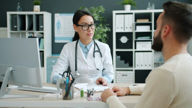 An adult reviews life insurance paperwork with a folder of medical records and prescription information.